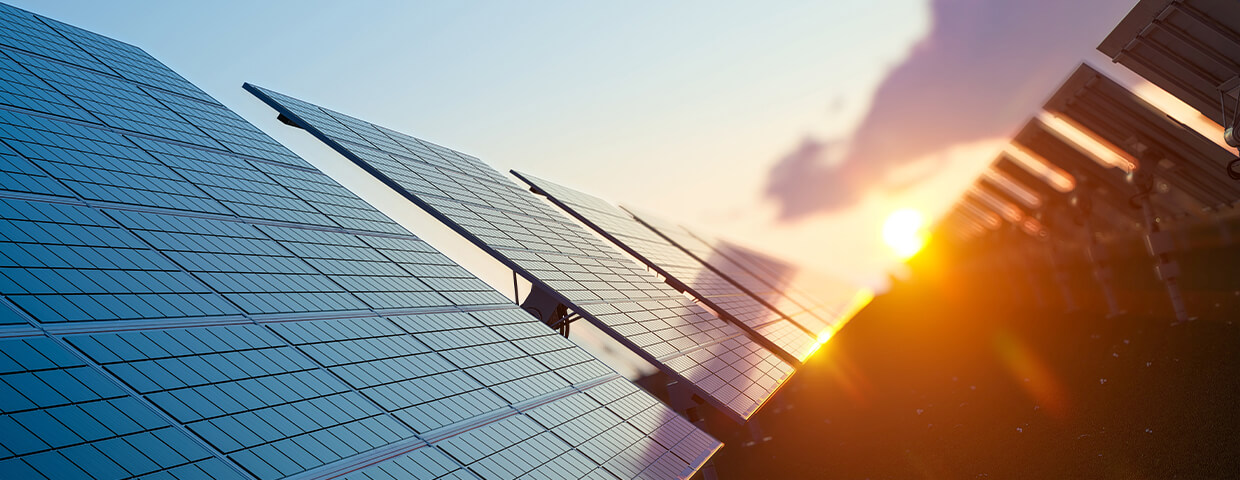 Solar panels in front of sunset
