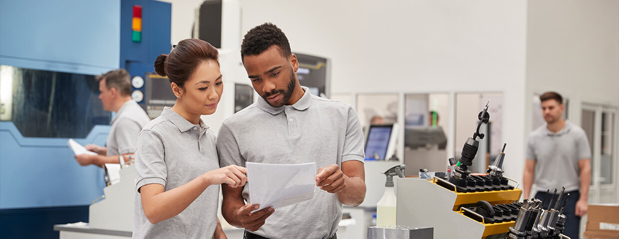People reviewing print out near printer